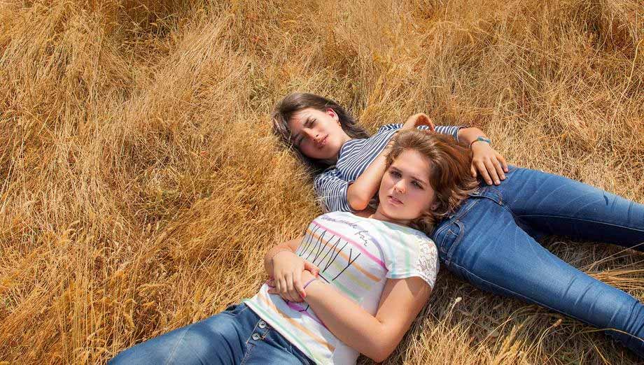 Deux adolescentes couchées dans l'herbe. Extrait du film Adolescentes de Sébastien Lifshitz